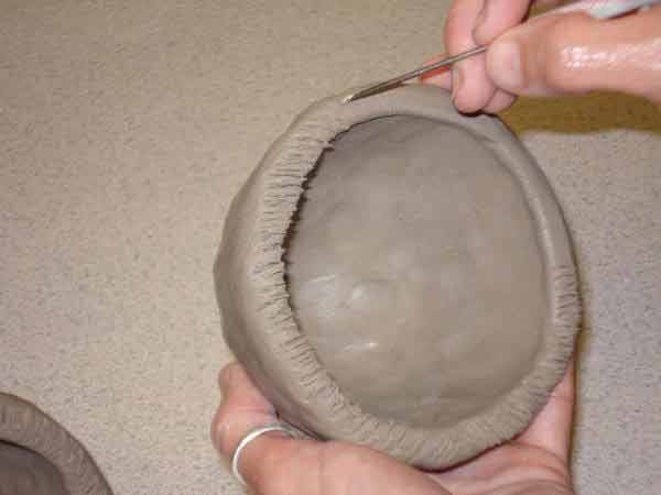 score both halves of pinch pot