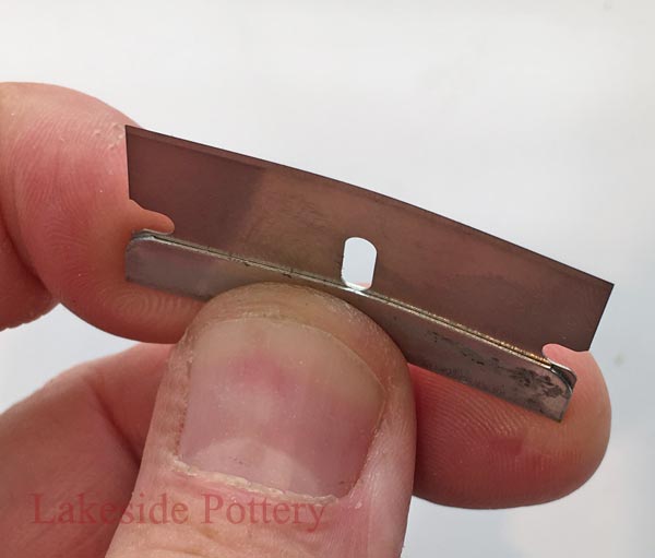 Bend blade for better access clearing unwanted cured epoxy