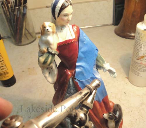 Protect rest of statue with tape and spray / brush colors